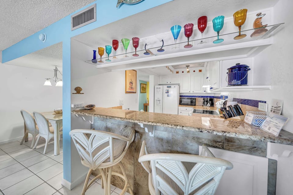 There is a dining table, perfect for enjoying a meal or playing a game, as well as additional breakfast bar seating.