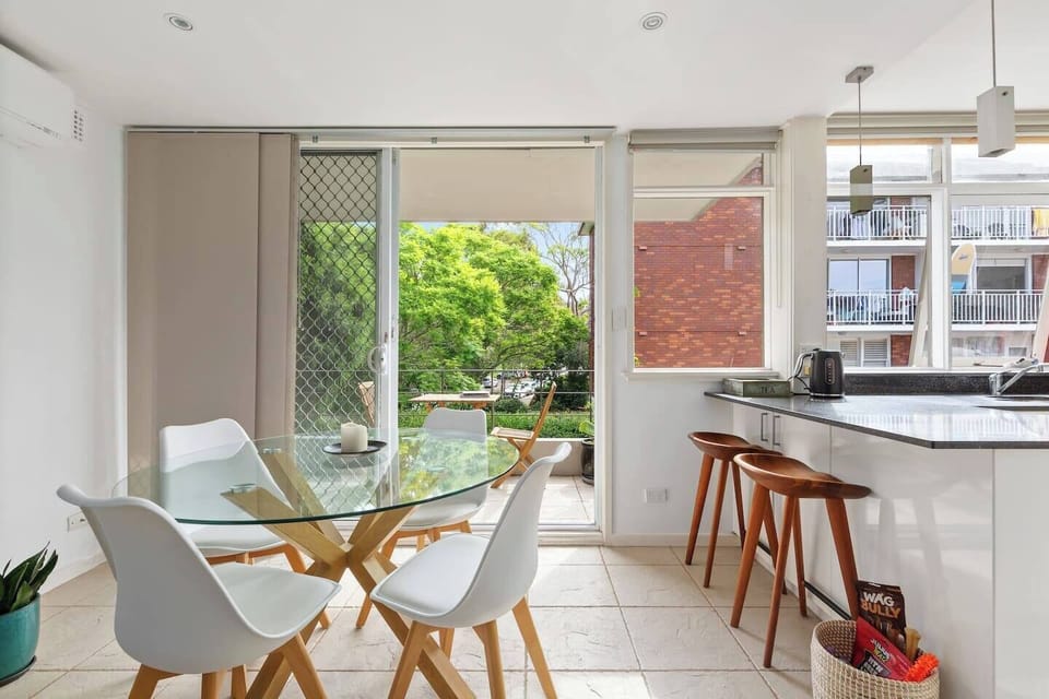 Gather around the four-seater dining table and enjoy meals with a view of the private balcony and lush greenery, blending indoor comfort with outdoor serenity.