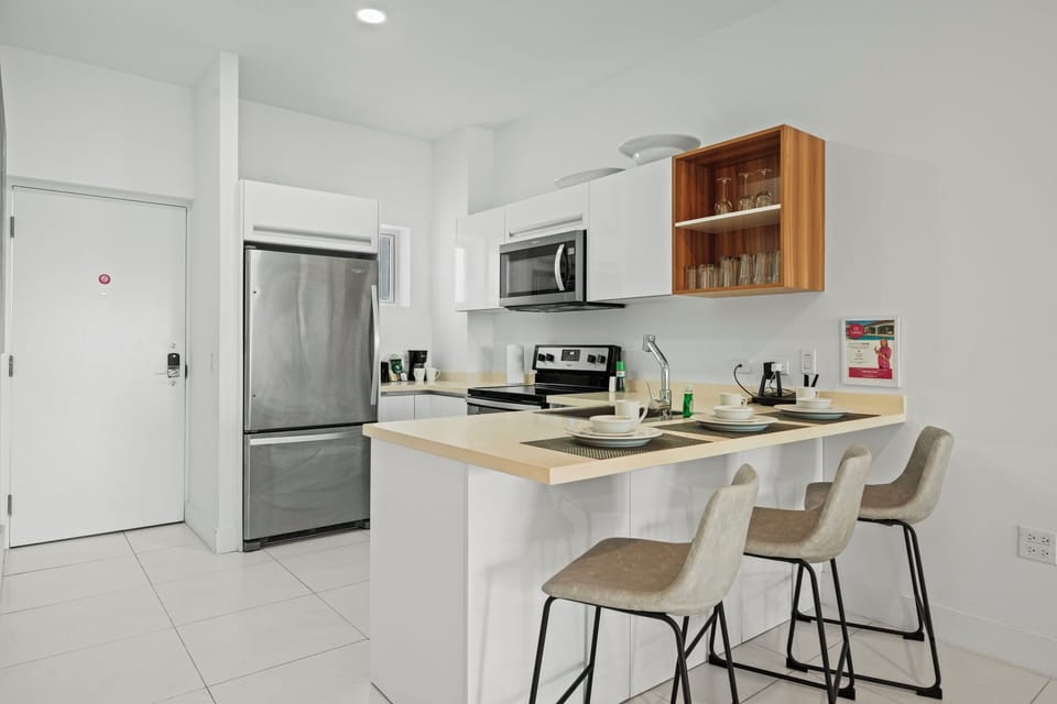Bright and open kitchen featuring modern appliances and plenty of counter space - Seamlessly connects to the living area with natural light pouring through large windows - Ideal for preparing meals and enjoying quality time with family and friends