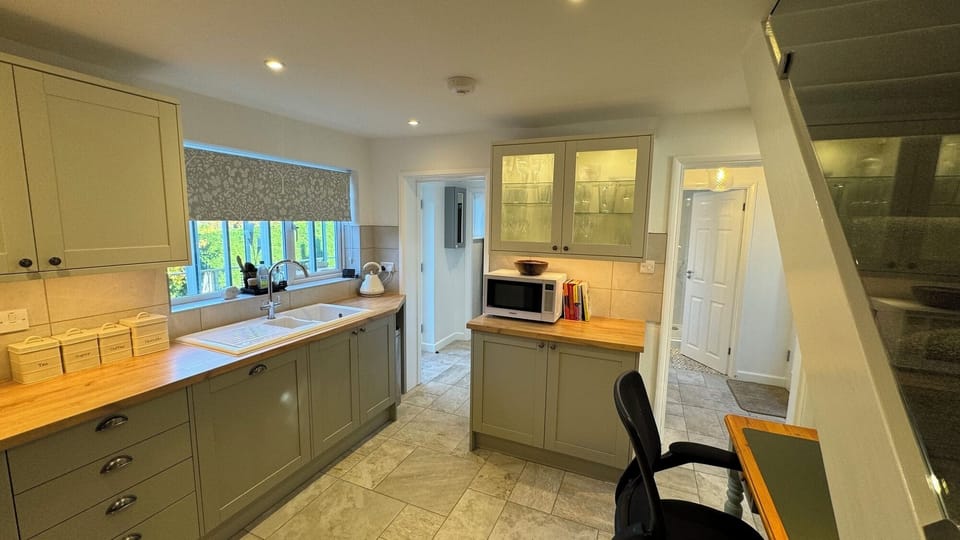 Kitchen with view towards hall and conservatory, with combo-microwave