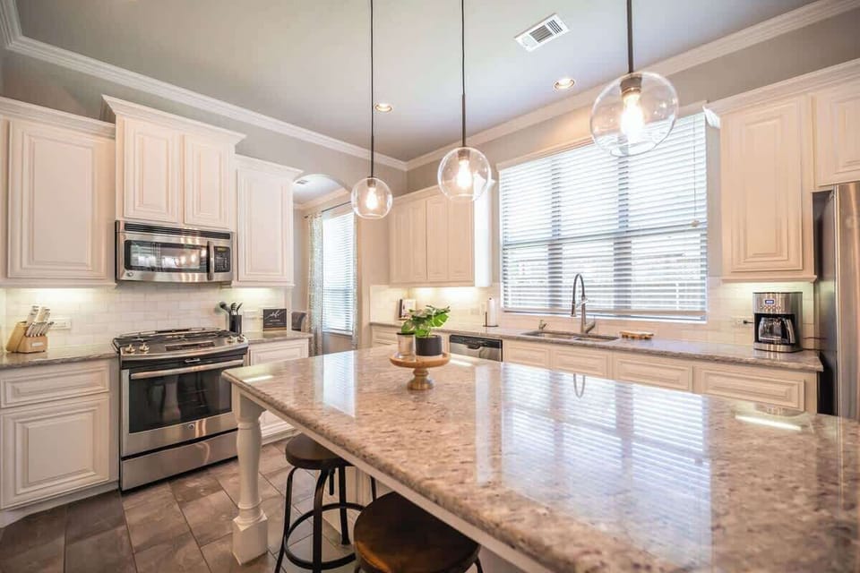 Beautiful Kitchen with Spacious Counter Top and Stainless Steel Appliances
