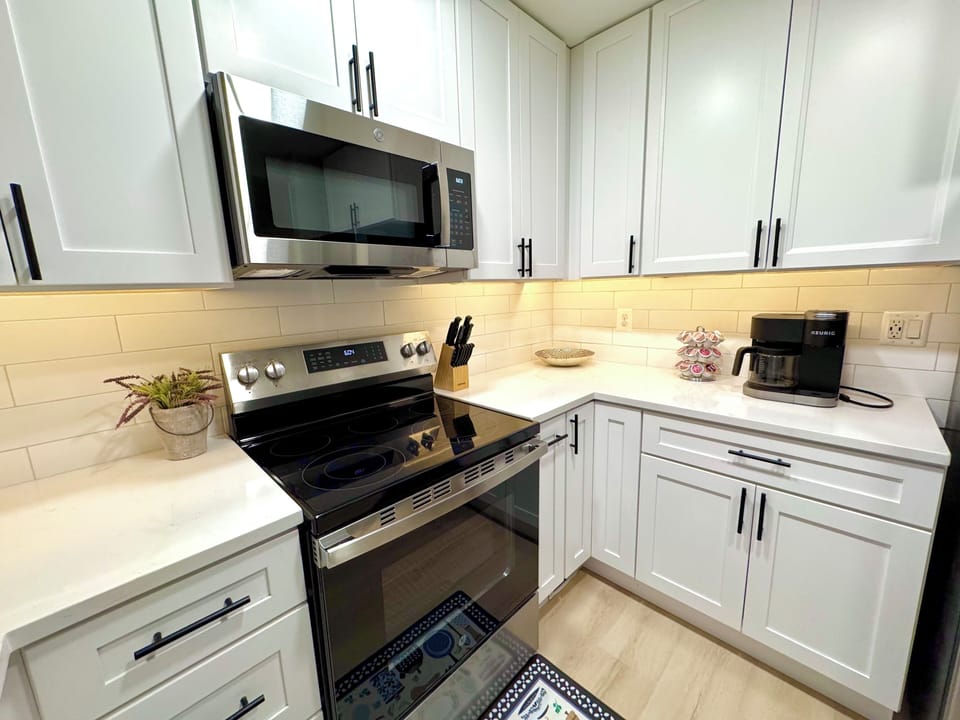 Full kitchen stocked with cooking and coffee supplies