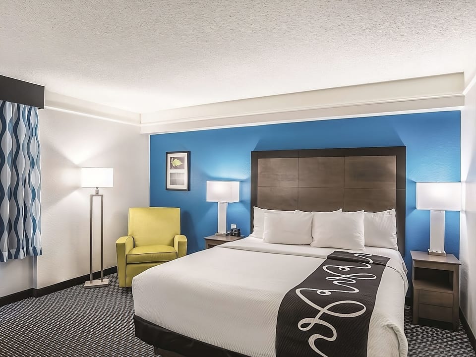 Unwind in a crisp king bed with soothing blue accents.