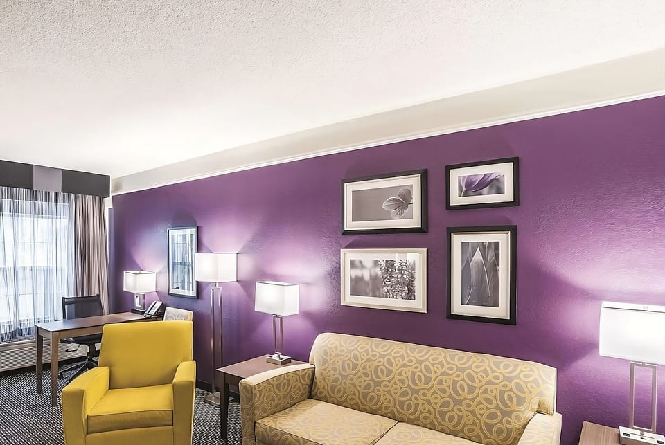 Kick back on the sofa beneath warm lighting and bold accents.