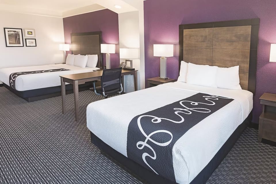 Work and relax easily with a desk between plush beds.
