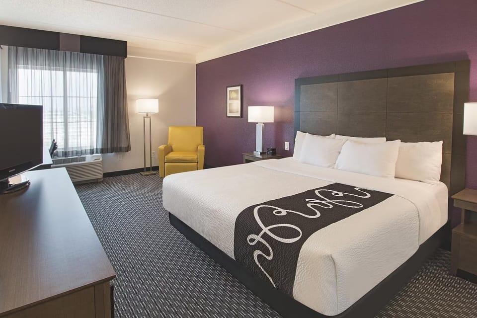 Unwind in a bright king room with cozy seating.