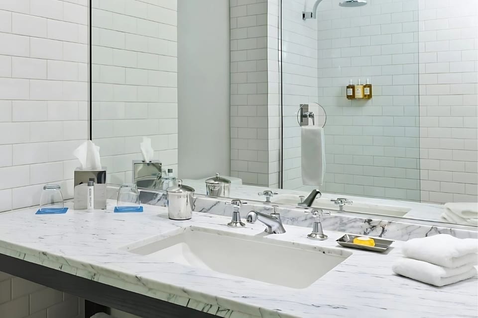 Refresh at the sleek marble vanity with bright, spotless finishes.