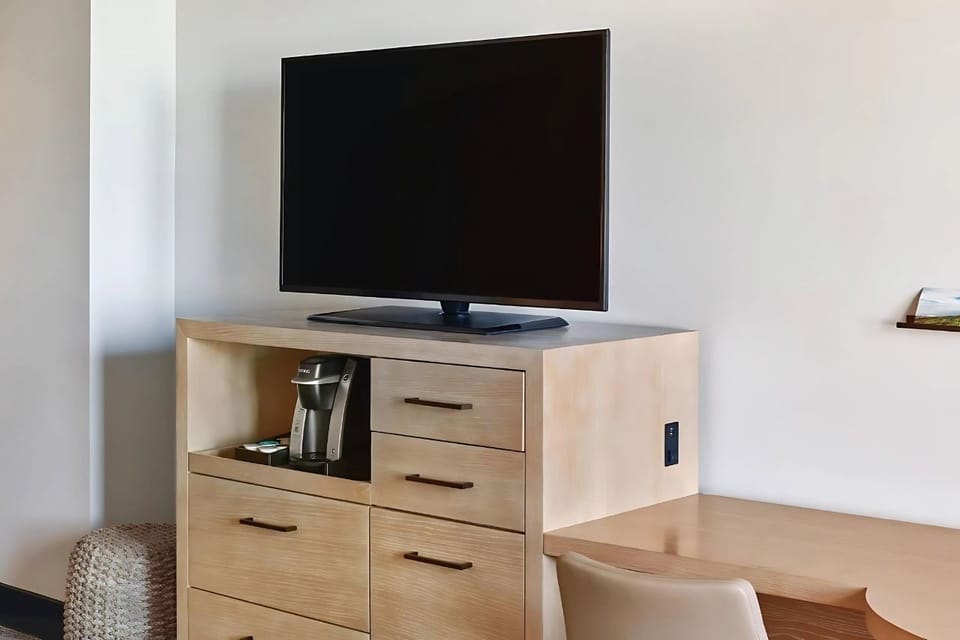 Settle in with a roomy desk, TV, and smart storage.