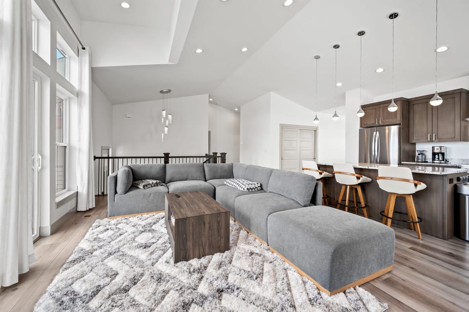 The open-concept living space, complete with a dining area, facilitates effortless conversation with family and friends.