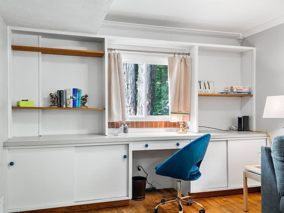 Built-in workspace w/ desk, shelves & window views for a bright work spot
