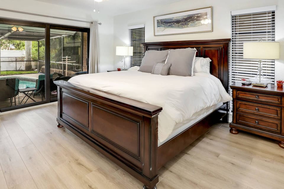 The primary bedroom features a king bed and lanai views.
