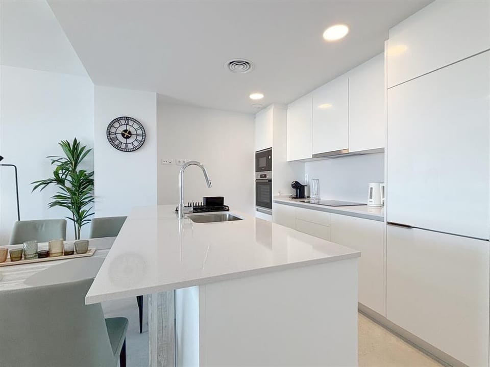 Modern kitchen in this apartment is fully equipped with all the appliances
