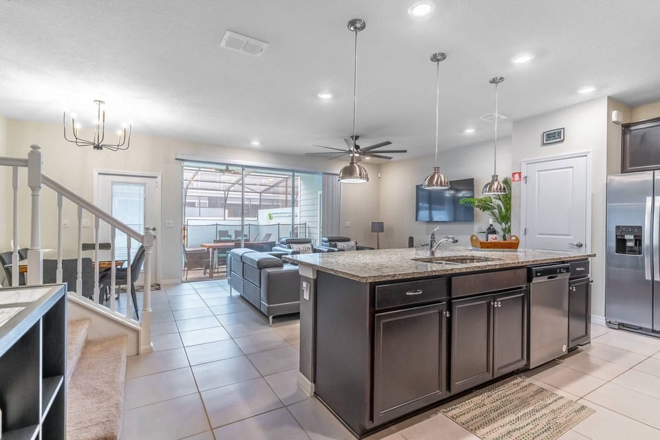 Lovely open concept Kitchen - dining - living area with access to the rear private patio and pool