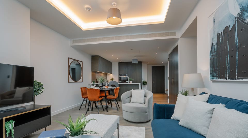This large living room has a designated lounge, kitchen & dining space