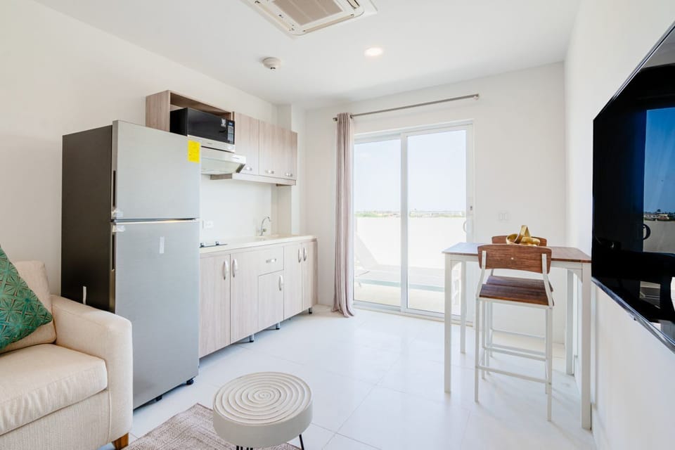 Cook effortlessly in a modern kitchenette with everything you need for meals - Bright dining nook opens to a balcony, offering indoor and outdoor flow - Designed for comfort and practicality, this space ensures a stress free experience