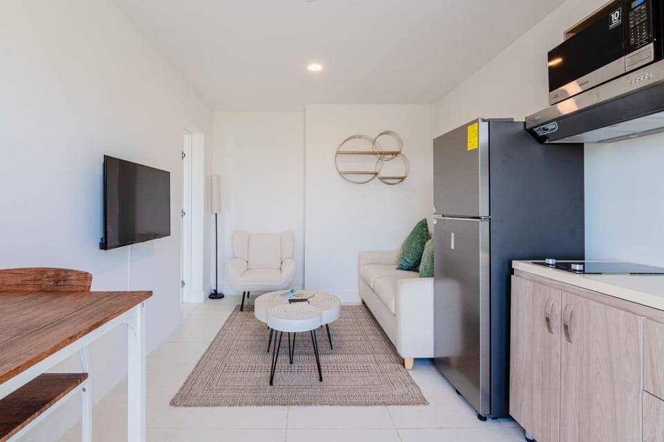 Unwind in a bright living area with stylish decor and cozy furnishings - Open plan layout offers a perfect spot for relaxing, dining, or watching your favorite shows - Thoughtful design, this space feels warm and welcoming for your stay