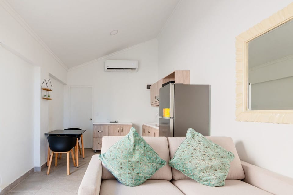 Cozy living room with soothing decor and seating, perfect for relaxing together - Spend quality time, enjoy a movie, or play games with family and friends - Seamlessly connected to dining area and kitchen space for easy, shared moments