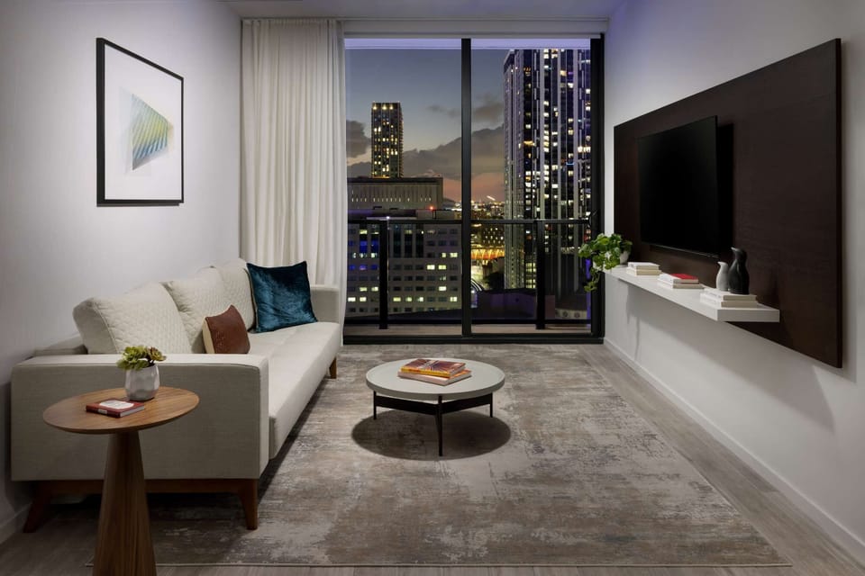 Living room with night city view balcony.