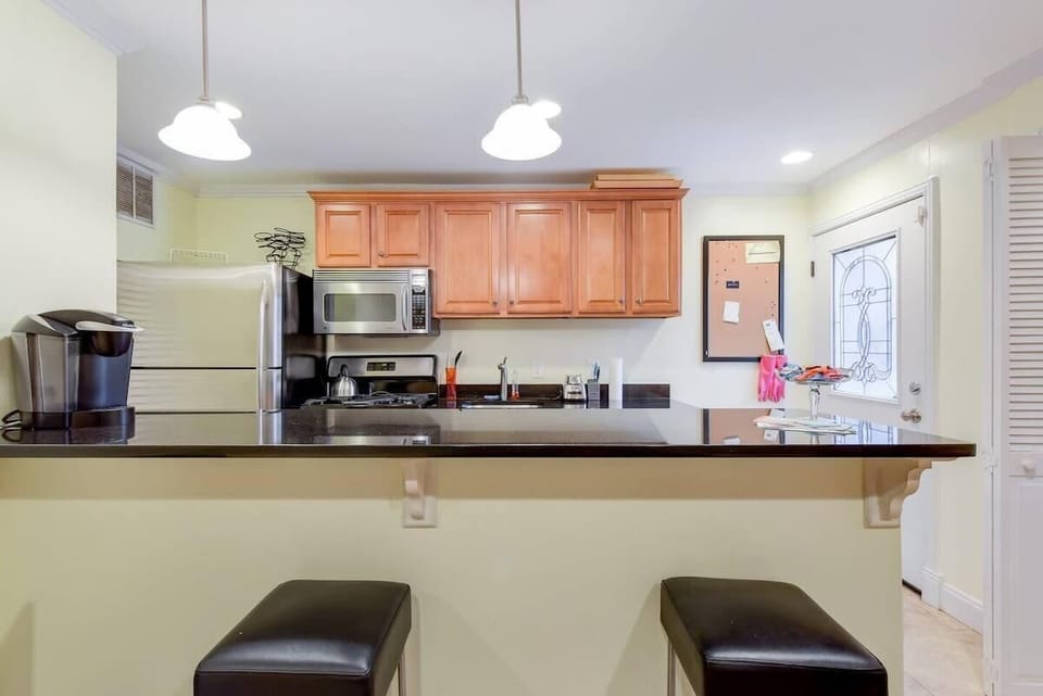 The kitchen area with bar stools (now four and they're wood)