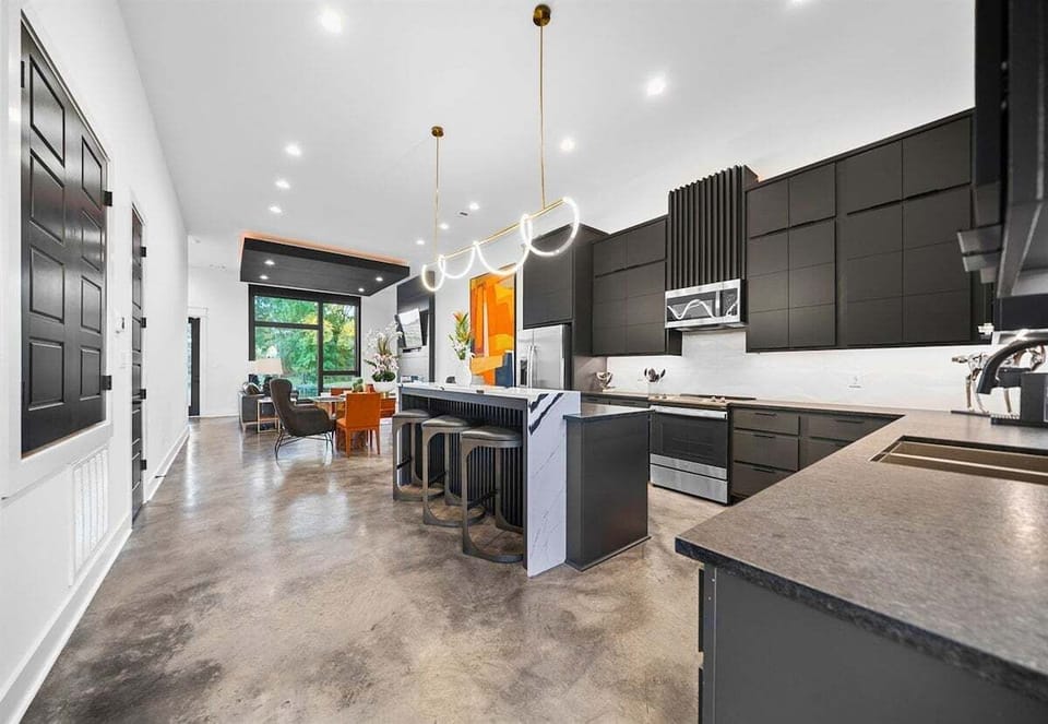 The open-concept layout showcases a sleek kitchen with high-end finishes, seamlessly flowing into the rest of the home for easy entertaining.