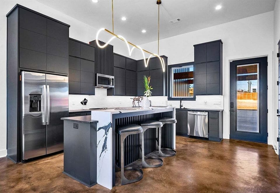 A seamless blend of elegance and functionality, this open-concept kitchen and dining area features sleek finishes, a spacious island, and thoughtful design touches.