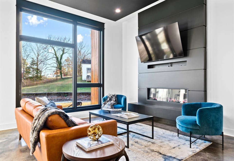 A warm and cozy seating nook, bathed in natural light, combines contemporary design with inviting textures for a relaxing retreat.