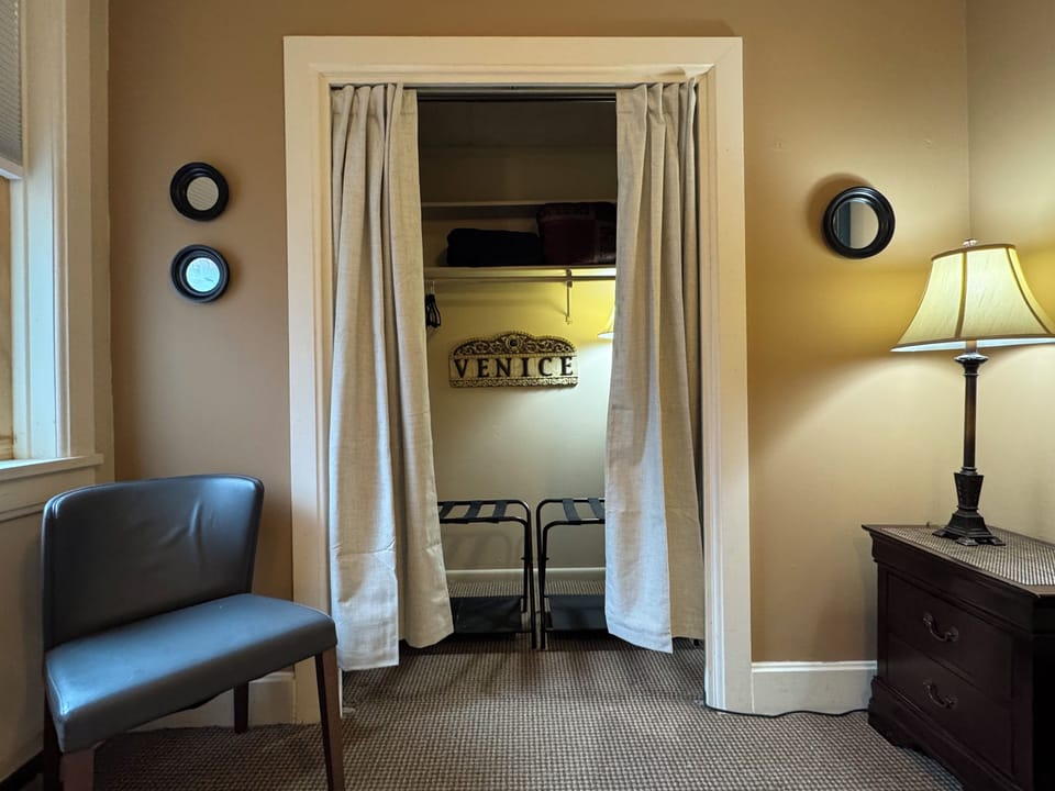 Closet w/ 2 luggage stands, iron/board, hangers, dresser, extra pillow/blankets