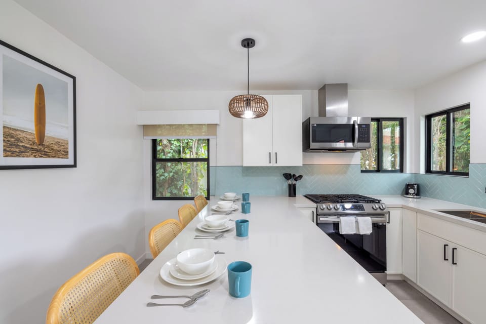 kitchen bar table with stools and stove and oven