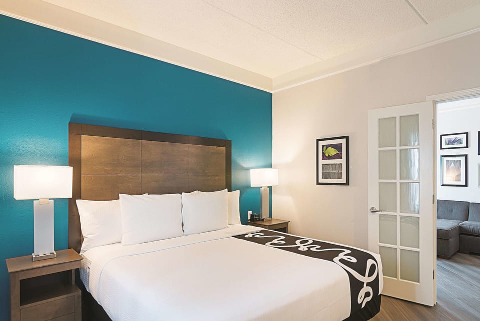 Drift off in a serene king room with warm lamps.