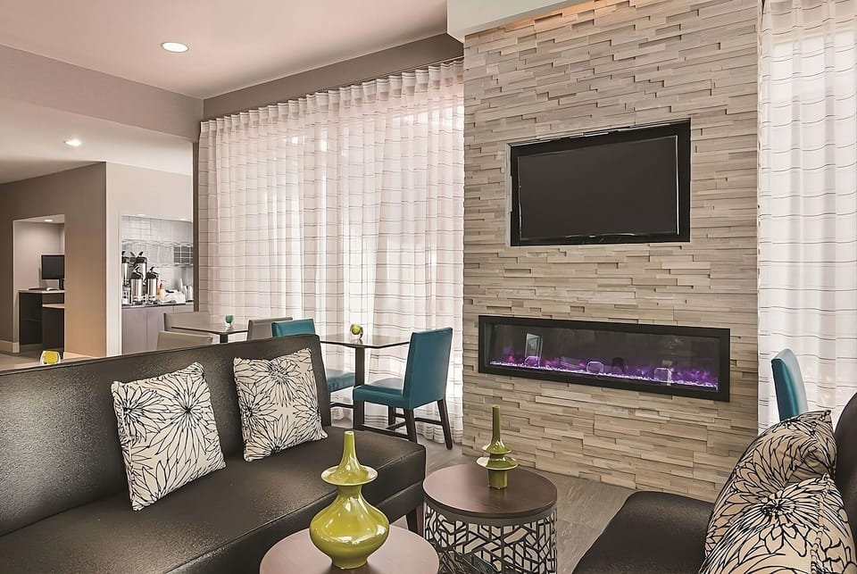 Gather by the modern fireplace for cozy evening conversation.