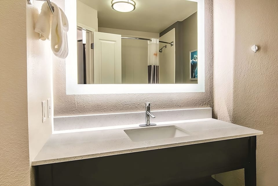 Refresh at the bright vanity with sleek, modern lighting.