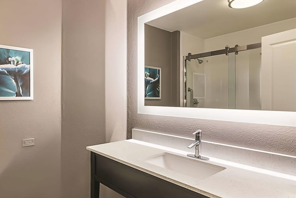 Refresh at the bright vanity with a spacious, modern sink.