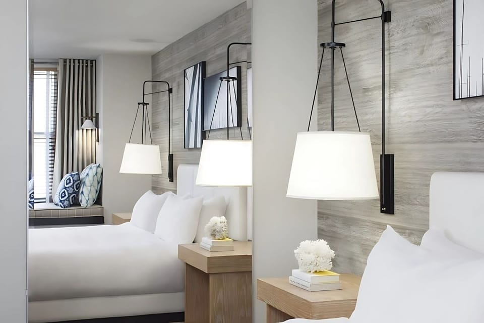 Stretch out in serene, modern comfort with warm bedside lighting.