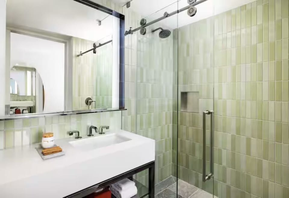 Refresh under the rainfall shower in a serene tiled suite.