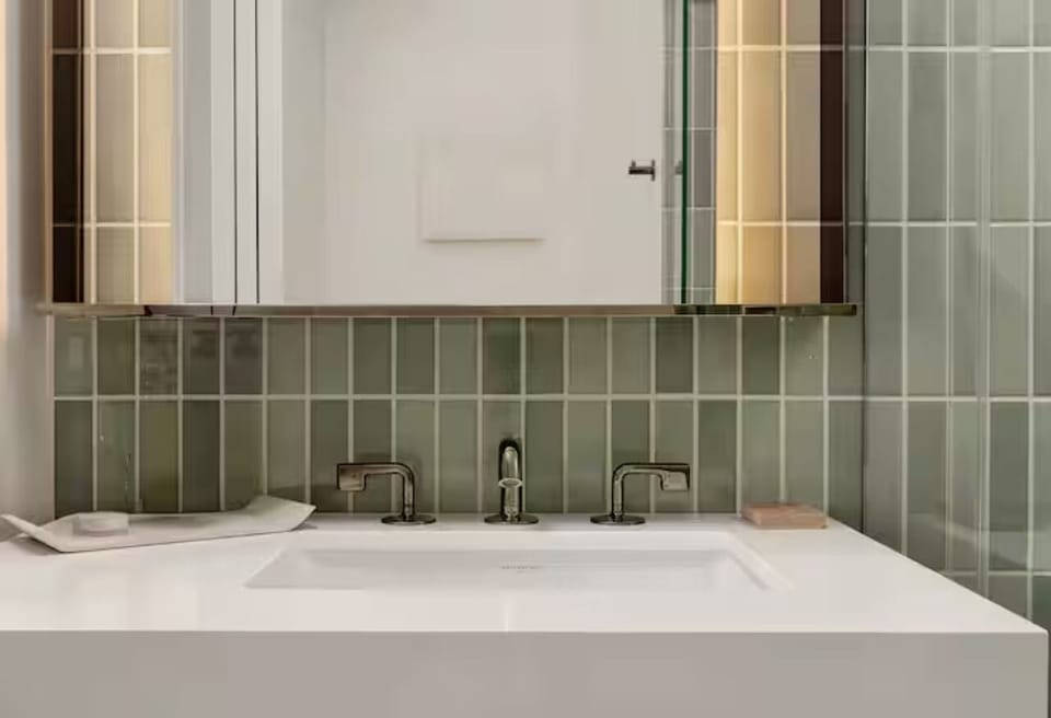 Unwind at the sleek vanity with warm, flattering lighting.