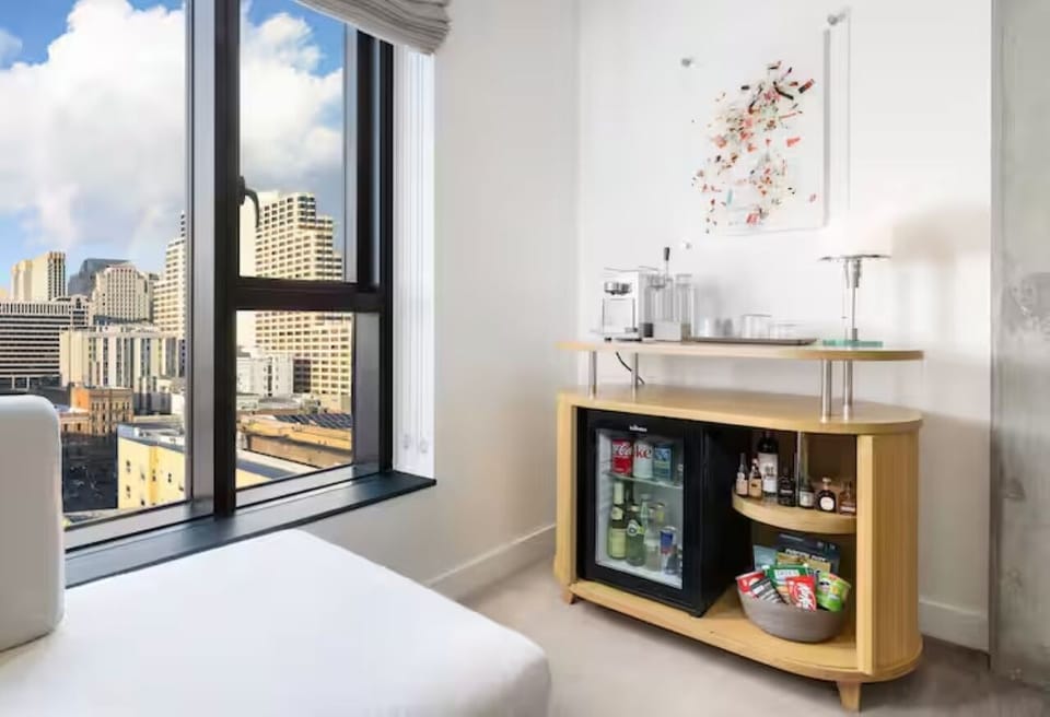 Enjoy a stocked minibar and skyline backdrop from your room.