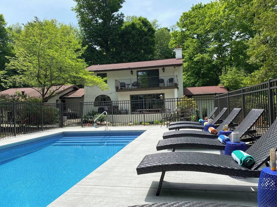 Heated pool with lounge chairs in the backyard