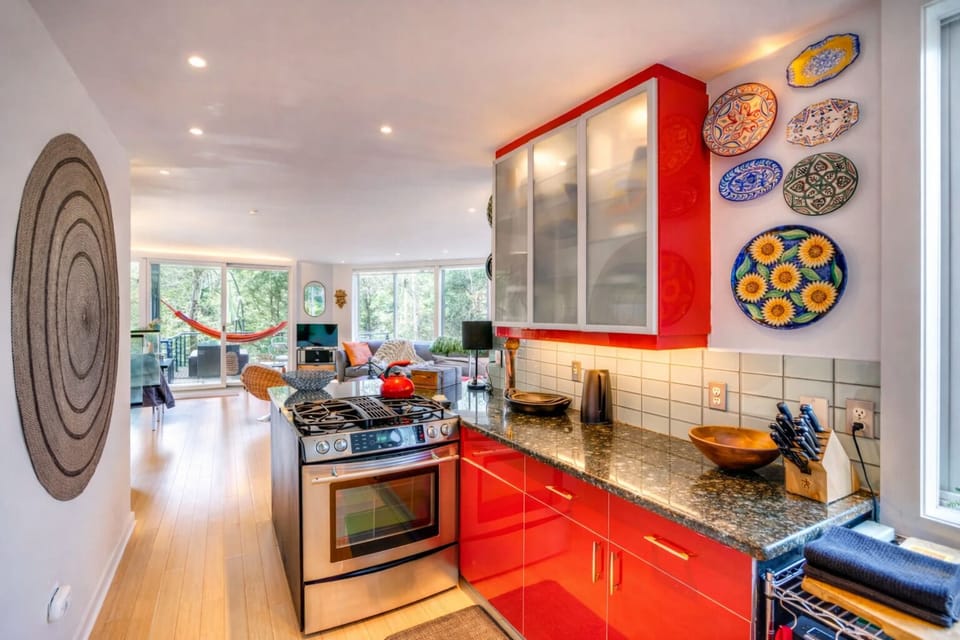 Cook facing your people, fireplace glowing with forest view.