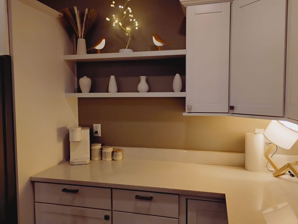 Coffee machine in kitchen. Coffee and cream provided