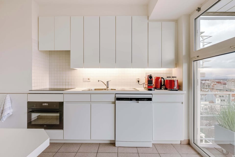 Bright, modern kitchen with city views and essentials!