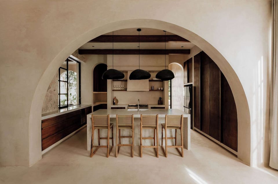 The kitchen opens through an arch — cooking never felt this good.