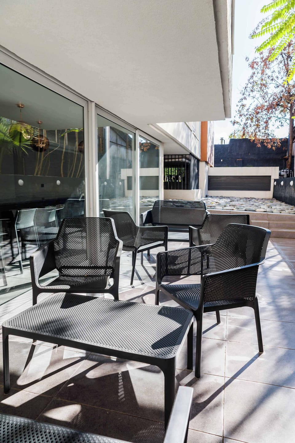 Relax in this stylish outdoor seating area, perfect for enjoying sunny days and fresh air.