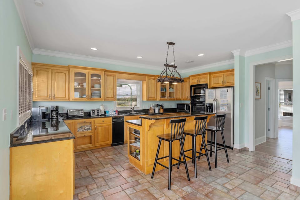 The inviting, open kitchen offers ample space & every home comfort