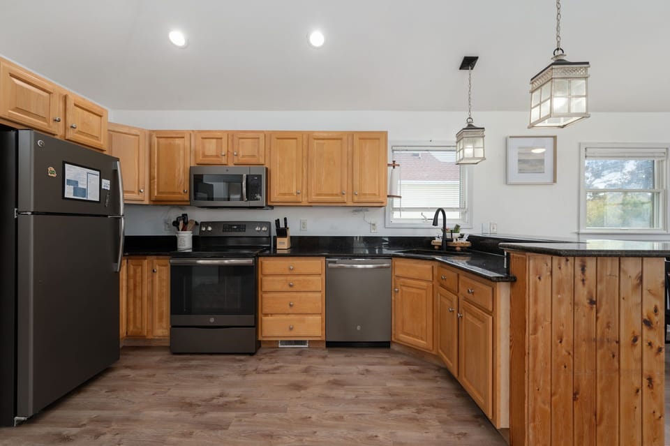 Well-appointed kitchen featuring granite countertops, upgraded appliances, and a breakfast bar, ideal for preparing home-cooked meals.