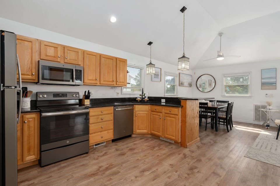 Well-appointed kitchen featuring granite countertops, upgraded appliances, and a breakfast bar, ideal for preparing home-cooked meals.