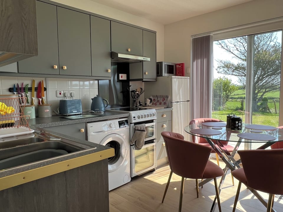 Kitchenette with dishwasher and washing machine.
