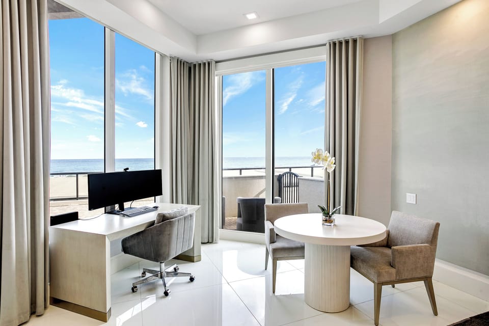 Large windows with sliding door, 12' ceilings with unobstructed ocean views.