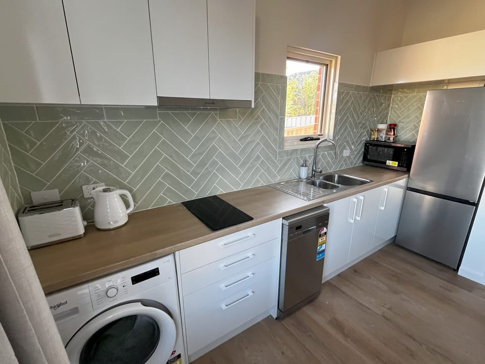 The modern kitchen is fully equipped with everything you'll need for your stay.