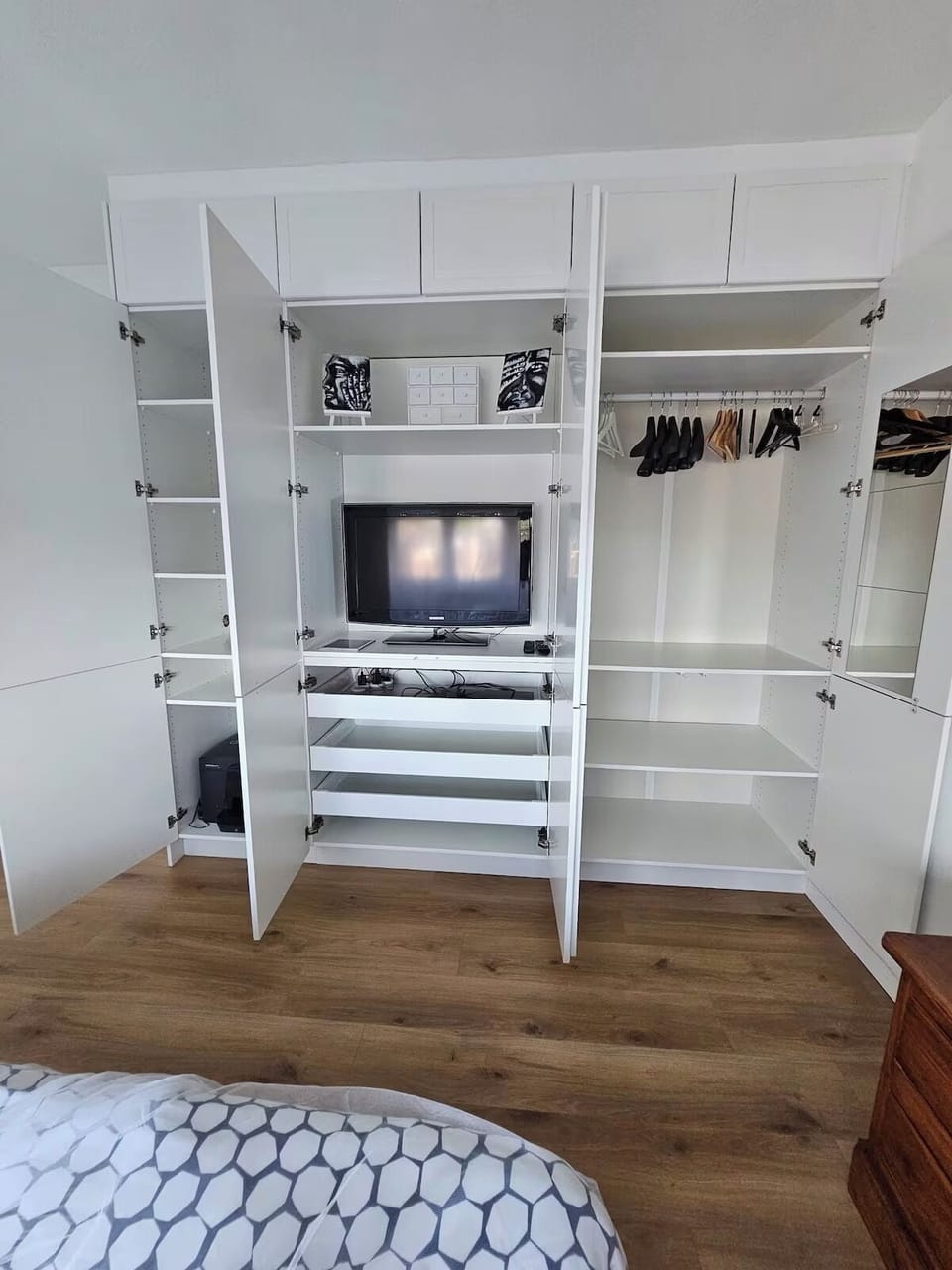 Built-in dressing cupboard in master bedroom with second TV