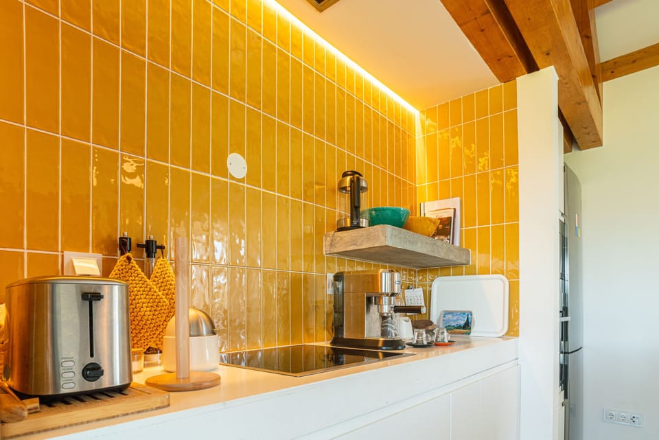 Modern kitchen with yellow tiled backsplash and wooden countertop — Villa do Pinheiro, luxury holiday villa in Grândola